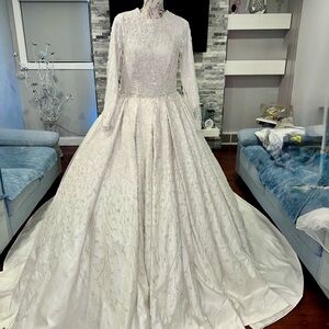 Elegant offWhite Beaded Wedding Gown long sleeve with veil included .